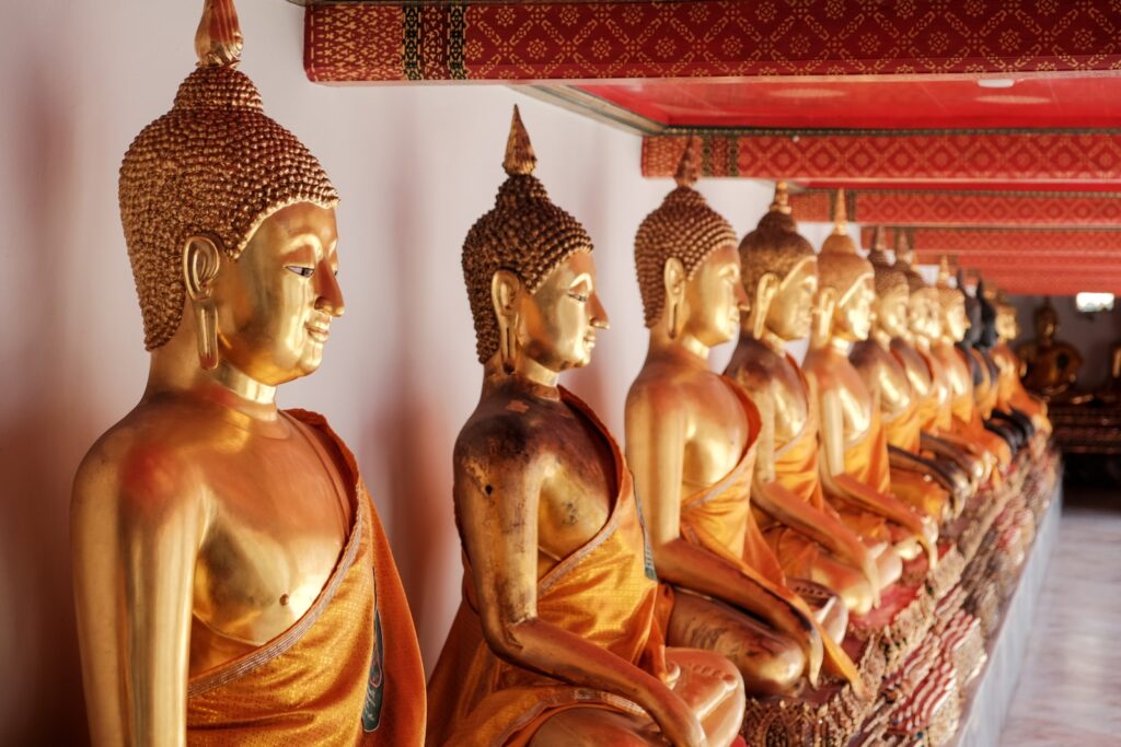 Wat Pho gold buddha statue on red and white textile